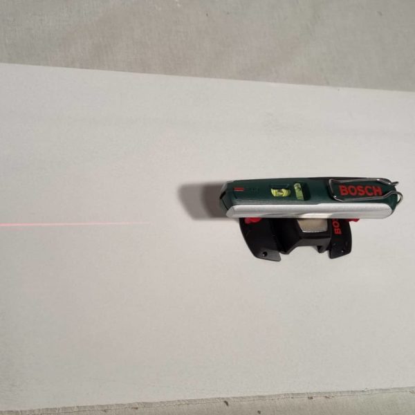 photo d'un niveau laser disposé sur son support mural